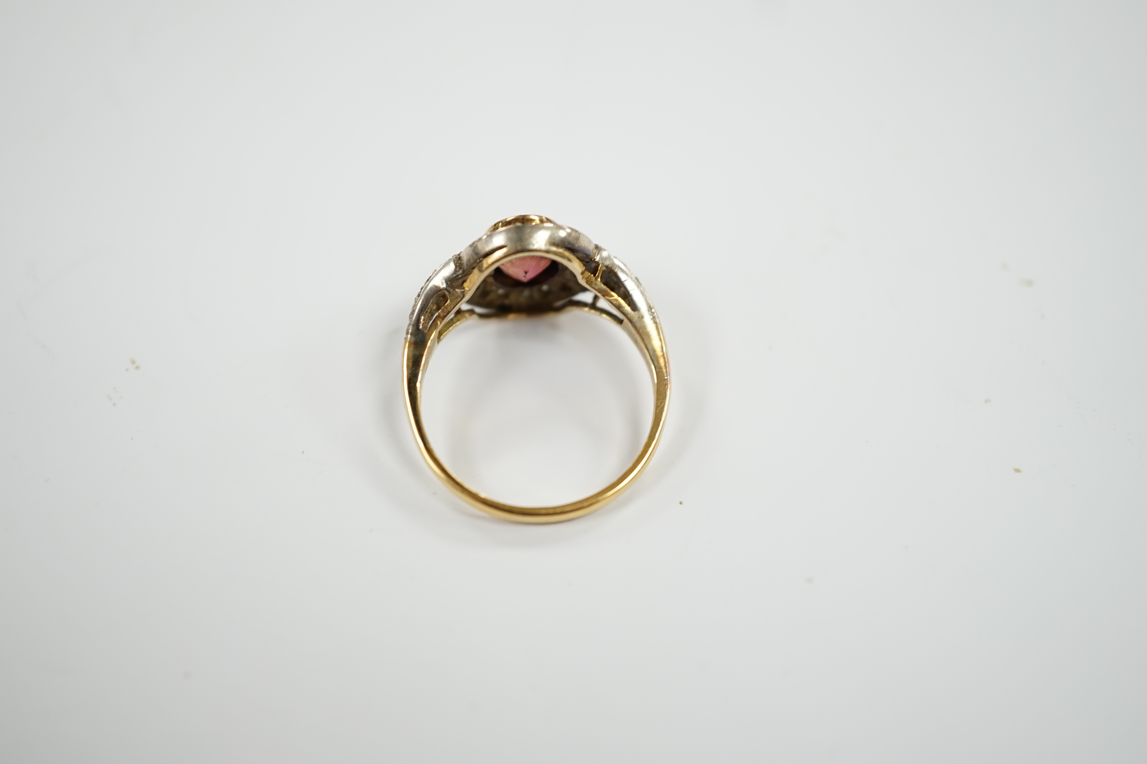 An 18ct, deep pink tourmaline and diamond set oval cluster ring, size P/Q, 4.4 grams